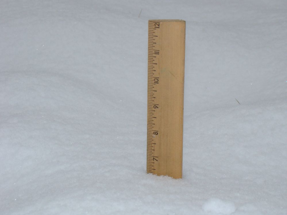 Using a ruler in my back yard to measure the amount of snow.