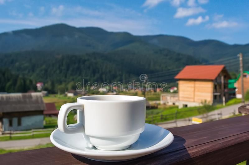 cup-tea-coffee-standing-porch-hotel-balcony-overlooking-mountains-early-morning-sunlight-123880698.jpg