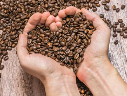 hands-holding-coffee-beans-heart-shape-pile-arabica-47953115.jpg