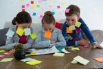 83441524-kids-as-business-executives-playing-with-sticky-notes-in-office.jpg