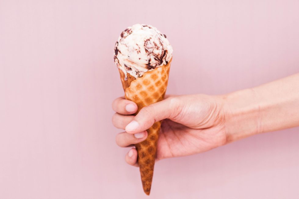young-woman-is-holding-an-ice-cream-on-an-ice-cream-royalty-free-image-1032703148-1559589761.jpg