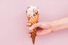 young-woman-is-holding-an-ice-cream-on-an-ice-cream-royalty-free-image-1032703148-1559589761.jpg